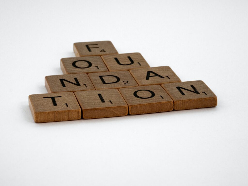 Scrabble blocks spelling "Foundation." You can't have "Foundation Models" without "Foundation."